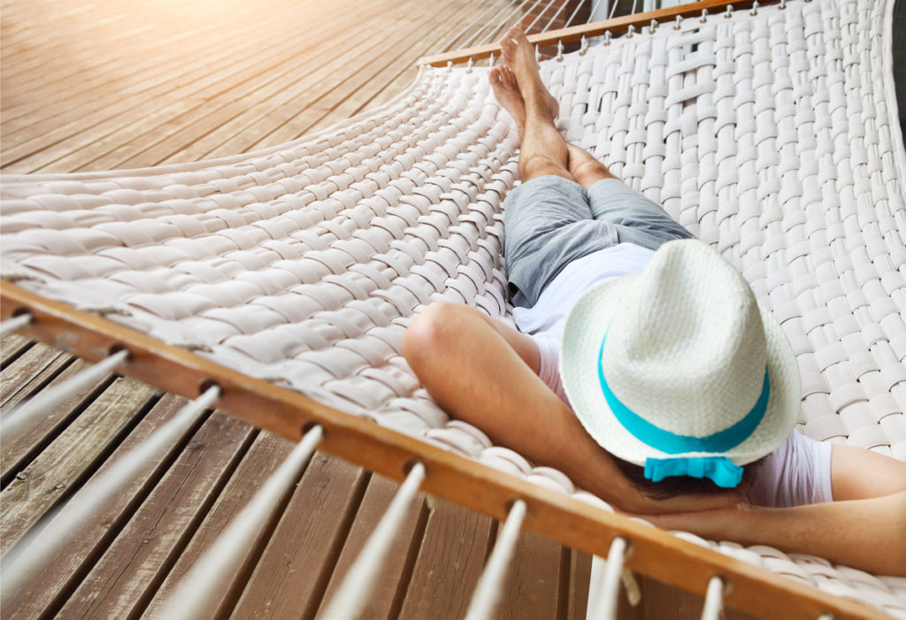 passive income photography - man lazing in a hammock