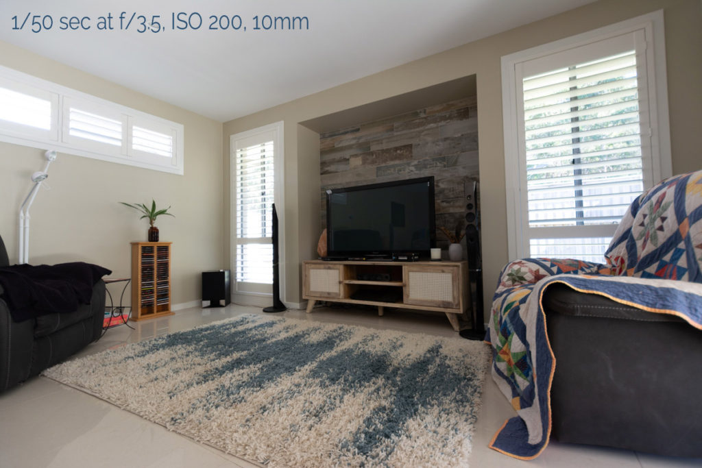 tamron 10-24mm lens review - an image of a lounge room with a tv, cd tower, arm chairs and shuttered windows